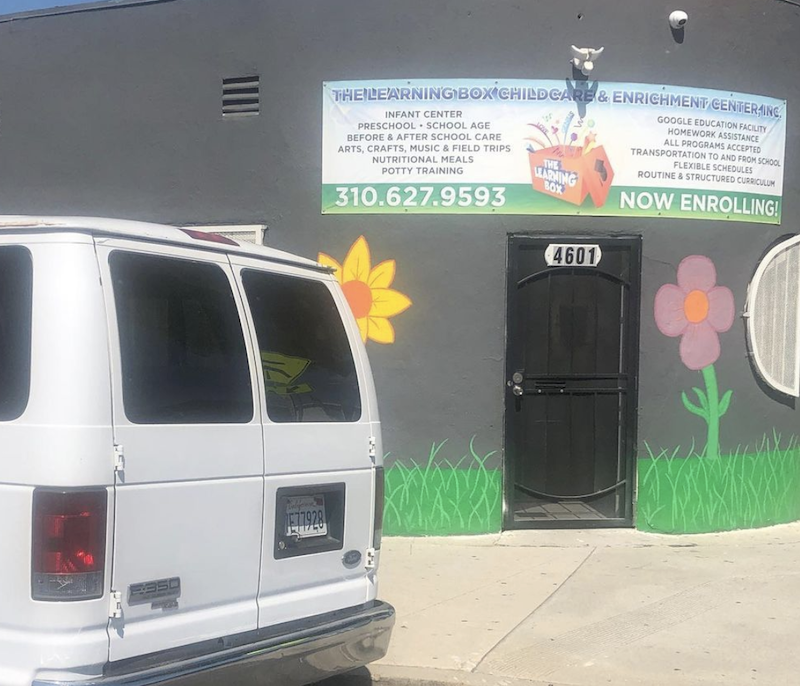 The Learning Box van parked out front of the building with a banner listing all the taught programs.